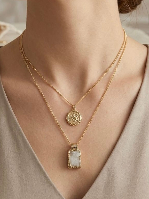 Layered gold necklace featuring a vintage coin pendant and natural white druzy stone by Lumina Manor.