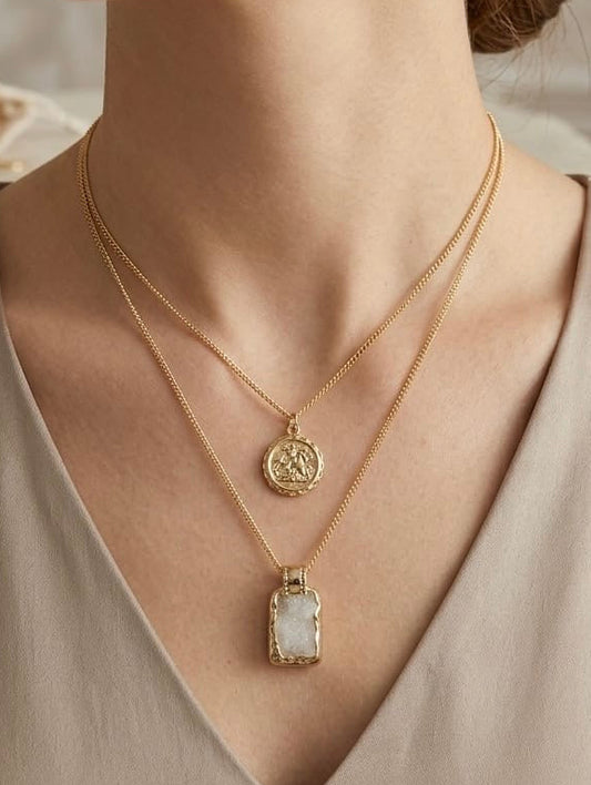 Layered gold necklace featuring a vintage coin pendant and natural white druzy stone by Lumina Manor.