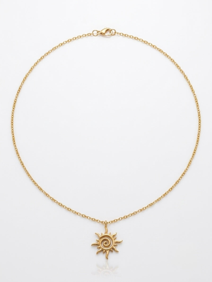 Gold spiral sun pendant necklace on a fine chain by Lumina Manor.