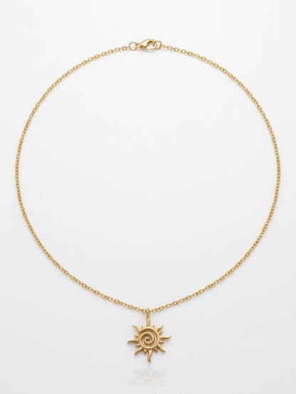Gold spiral sun pendant necklace on a fine chain by Lumina Manor.