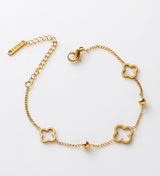 Golden stainless steel clover bracelet with adjustable chain and polished bead accents by Lumina Manor.